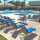 Clear photo of the main pool area with lounge chairs and umbrellas, showing guest amenities and adjacent buildings — matches resort pool images on the property page.