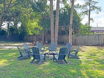 Outdoor firepit seating area on grass — highlights an additional common amenity and outdoor gathering space on the property.