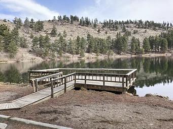 Wooden fishing pier on a lake.