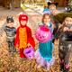 Children in Halloween costumes on a leaf-covered lawn — illustrates seasonal campground events and family activities taking place on the property (used as a hero/event-style image on the site).