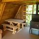 Twin Lakes Cabin (AK) interior showing wood table and stove with vertical ladder to loft
