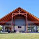 Clear daytime exterior of the main lodge/entry pavilion showing building architecture, lawn and bike racks — useful as an overview of on-site facilities (image is from the property’s homepage/gallery).
