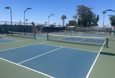 Image of multiple outdoor courts (tennis/pickleball area), illustrating on-site recreational facilities shown on the property’s activity gallery.