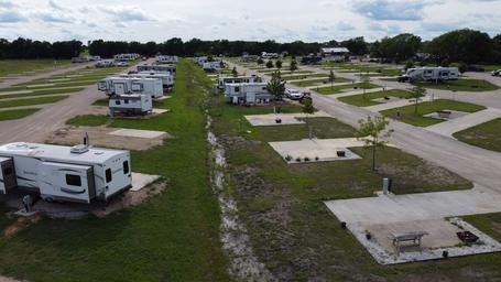 Drone/overhead image of the RV park showing multiple full-hookup pads, driveways and site spacing — useful close aerial for guests. File originates from the accommodations page.
