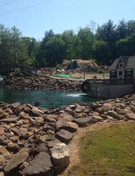 Miniature golf course and water feature with rock landscaping — shows the park’s miniature golf attraction and on-site recreational facilities (from the Amenities page).
