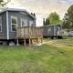 Two bunkhouses/cabins on grassy area with decks — useful to showcase on-site cabin/bunkhouse accommodations (from bunkhouses page).