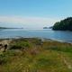 Wide waterfront shoreline view from the homepage showing rocky shore and bay — illustrates the campground’s coastal setting and water access.