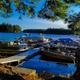 Boat docks with multiple boats and view across the lake — illustrates waterfront access and docking area (Amenities page).