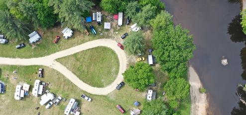 Campground with river and mountain in background