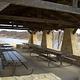 A view under the of the pavilion showing 4 picnic tables
