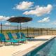 Poolside photo with lounge chairs and lake in the background — highlights on-site amenity and waterfront setting.