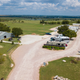 Clear aerial/drone view showing the overall RV park layout: rows of RV sites, access road, covered building and grounds. Source page is the site’s Gallery (gallery.html), confirming this is an on‑property overview image.