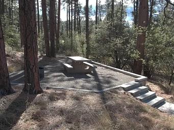 White Spar Campsite with table and fire ring on raised rock walled platform
