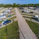 Campers and RVs on gravel pull through at Creek Side Resort in Hays, Kansas