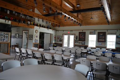 Interior photo of the clubhouse/event room showing seating and facility space — useful to illustrate indoor community amenities available to guests (source: Portfolio page).
