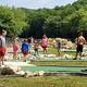 Mini-golf area with people playing — demonstrates on-site recreational amenity and layout (displayed on the Amenities page).
