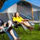Tent camping scene showing tent, chairs and grassy campsite — represents tent site accommodation and campground atmosphere (from ‘tent sites’ gallery context).