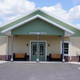 Front exterior of the clubhouse/office building showing entrance and accessible parking — helpful for arrival orientation and first-impression imagery (source: Home page).