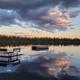 Wide, high-resolution lake view showing docks and calm water at sunset — matches homepage imagery of Little Muskie Lake and clearly depicts the resort waterfront (homepage header/gallery).