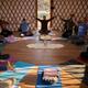 Interior of a yurt or group space with people doing yoga/meditation — demonstrates on-site program space and activities available to guests (from the property's gallery).