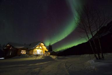 Aurora borealis behind the Log Cabin Wilderness Lodge