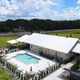 Aerial view of the clubhouse and swimming pool area, clearly showing the pool, deck, fencing and building — highlights on-site amenities (source: Portfolio page).