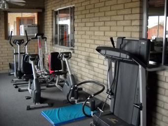 Indoor fitness equipment in a dedicated room with windows overlooking the grounds — represents the campground’s fitness amenity (source page: Amenities).
