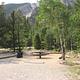 Campsite with picnic table and fire pit with mountain in background
