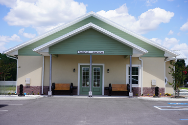 Front exterior of the clubhouse/office building showing entrance and accessible parking — helpful for arrival orientation and first-impression imagery (source: Home page).