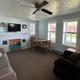 Interior living room photo of a rental unit showing seating, dining table and windows — useful to represent interior amenities of onsite rentals.