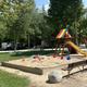Playground area with open green space and surrounding RVs/trees; a facility image used in the site's home banners showing on-site recreation.