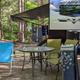 Clear ground-level photo of an RV campsite in a wooded setting with chairs, table, and vehicle — shows typical campsite setup and tree cover. Sourced from the site's homepage (Family Camping Near Silver Lake Sand Dunes) which hosts campground images.
