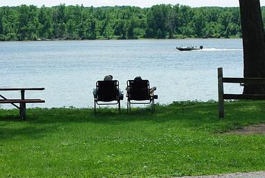 Lounging looking at the river with a speedboat going by.