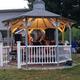 Gazebo with people/instruments in a lawn area — shows a communal gathering space on the property; from the site's About Us page (page title: ABOUT US | Mysite).
