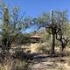 paved path to ramada 2, framed by desert plants