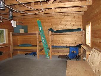 A view of bunks and bench inside Esker Stream Cabin (Wrangell-St Elias)