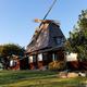 Distinctive windmill/clubhouse building on a grassy rise — a recognizable on-site landmark and part of the property’s character.