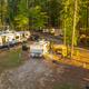 Elevated shot of multiple RV sites among tall pines, giving a sense of campsite layout and spacing — useful for prospective guests. Included in the resort’s gallery on the property page (page: Lake Gaston RV Camping | Thousand Trails RV Campground, URL provided).