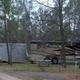 Large motorcoach parked at a wooded site with hookups visible — demonstrates availability of full‑size RV accommodations on the property. From the homepage slideshow.