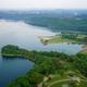 High-resolution aerial view of Lake Cumberland shoreline and surrounding green space/parkland — useful as a scenic site overview and local setting image used on the property's 'Things to Do' page.