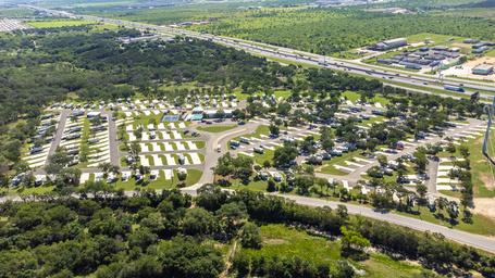 Aerial shot from a different angle that includes the resort, surrounding vegetation and nearby highway — good for location context and layout variety.
