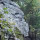 Close-up view of the Ledges rock formation and surrounding trees — matches the page for The Ledges campsites and shows a distinctive on‑site natural feature that provides privacy and character to the campground.