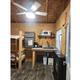 Interior of a cabin showing kitchenette, bunks and amenities — documents the inside features of the property’s cabins (cabin5-resized.jpg on ‘Our Resort’ page).