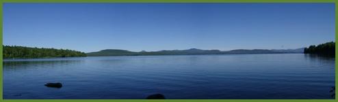 Panoramic lake vista with calm water and distant shorelines — illustrates the preserve’s lakefront scenery (from Contact Us / site imagery).