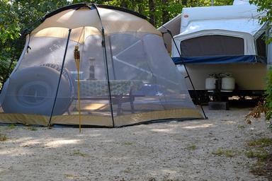 Tent and RV campsite setup showing ground surface, picnic table and immediate site layout — useful interior campsite view from the property’s amenities gallery.