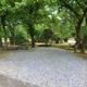 Front-facing campsite view with gravel pad, picnic table and wooded surroundings — representative guest site image from the property’s Sites page.