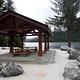 covered shelter with picnic tables and view of ocean