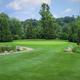 Well-framed view of a manicured green and fairway with landscape features — highlights the on-site golf facilities and course quality (from site’s gallery golf images).