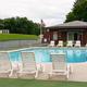 Pool area with chairs, surrounding deck and adjacent building — shows on-site recreation/facilities (labeled 'Campground Pool' on the site).