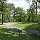 Single campsite with grill, picnic table and fire ring.